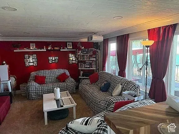 Living area featuring recessed lighting, a textured ceiling, built-in shelving, and large windows