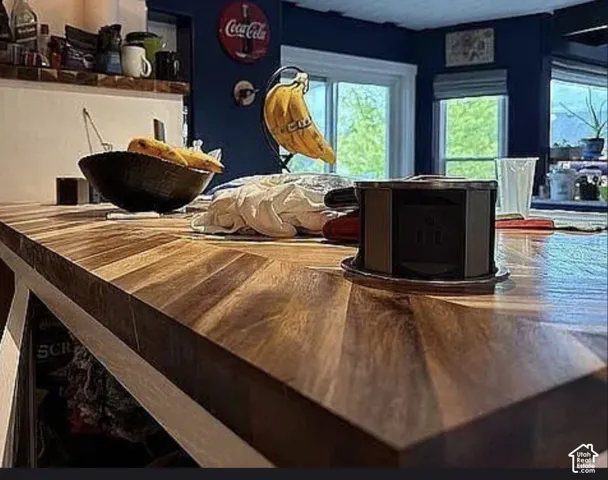 Countertop featuring a natural wood-finish surface arranged in a chevron pattern with an integrated, retractable power outlet
