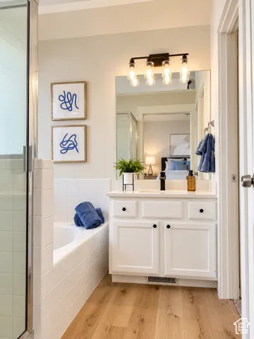 Primary ensuite, new flooring, lighting, paint, quartz countertop, faucet
