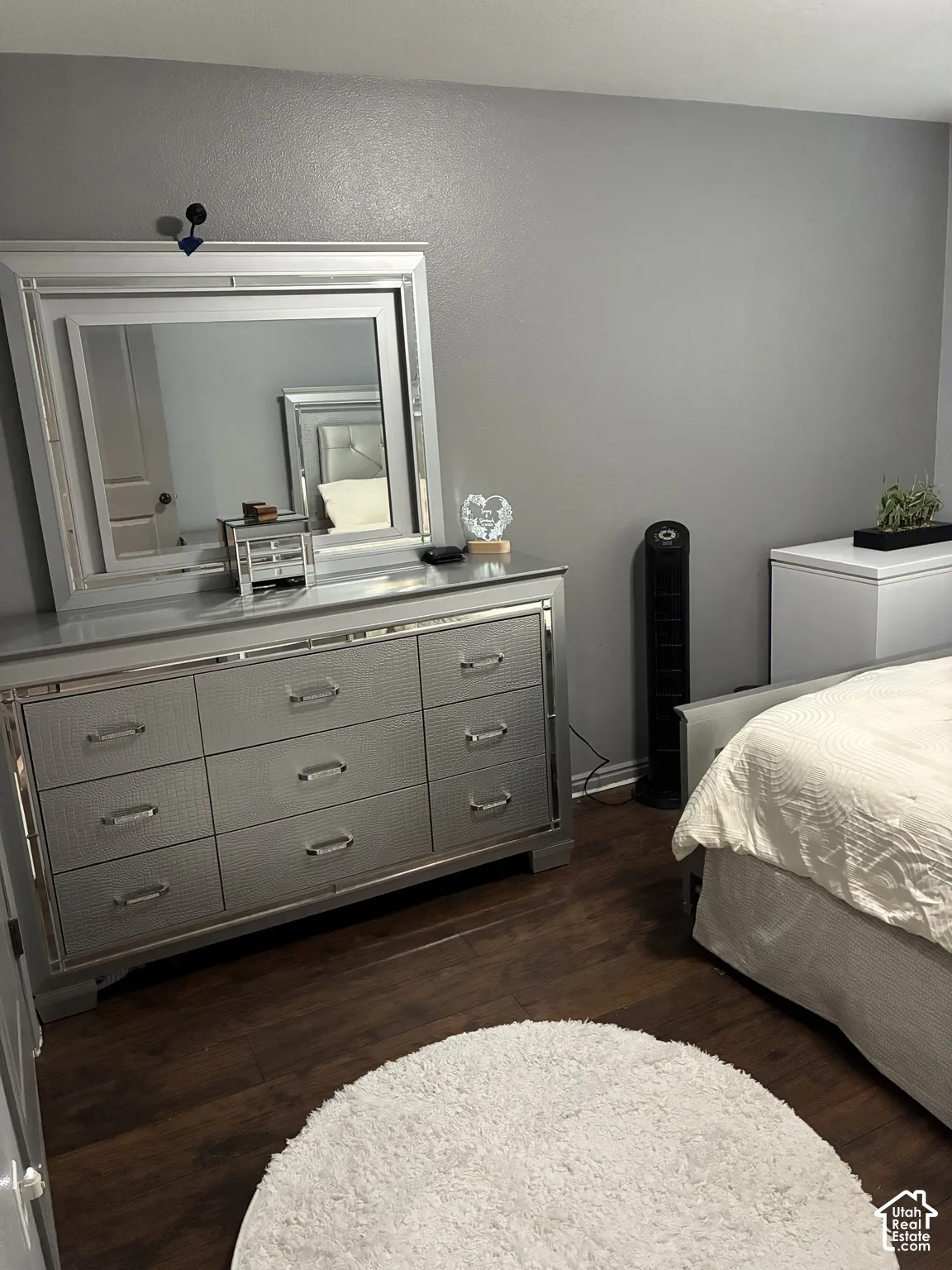 Room featuring wood-finish flooring, neutral wall paint, and a solid-core interior door