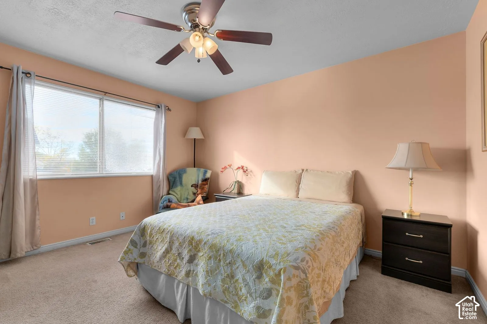 Room featuring a ceiling fan with integrated lighting and a large window with horizontal blinds