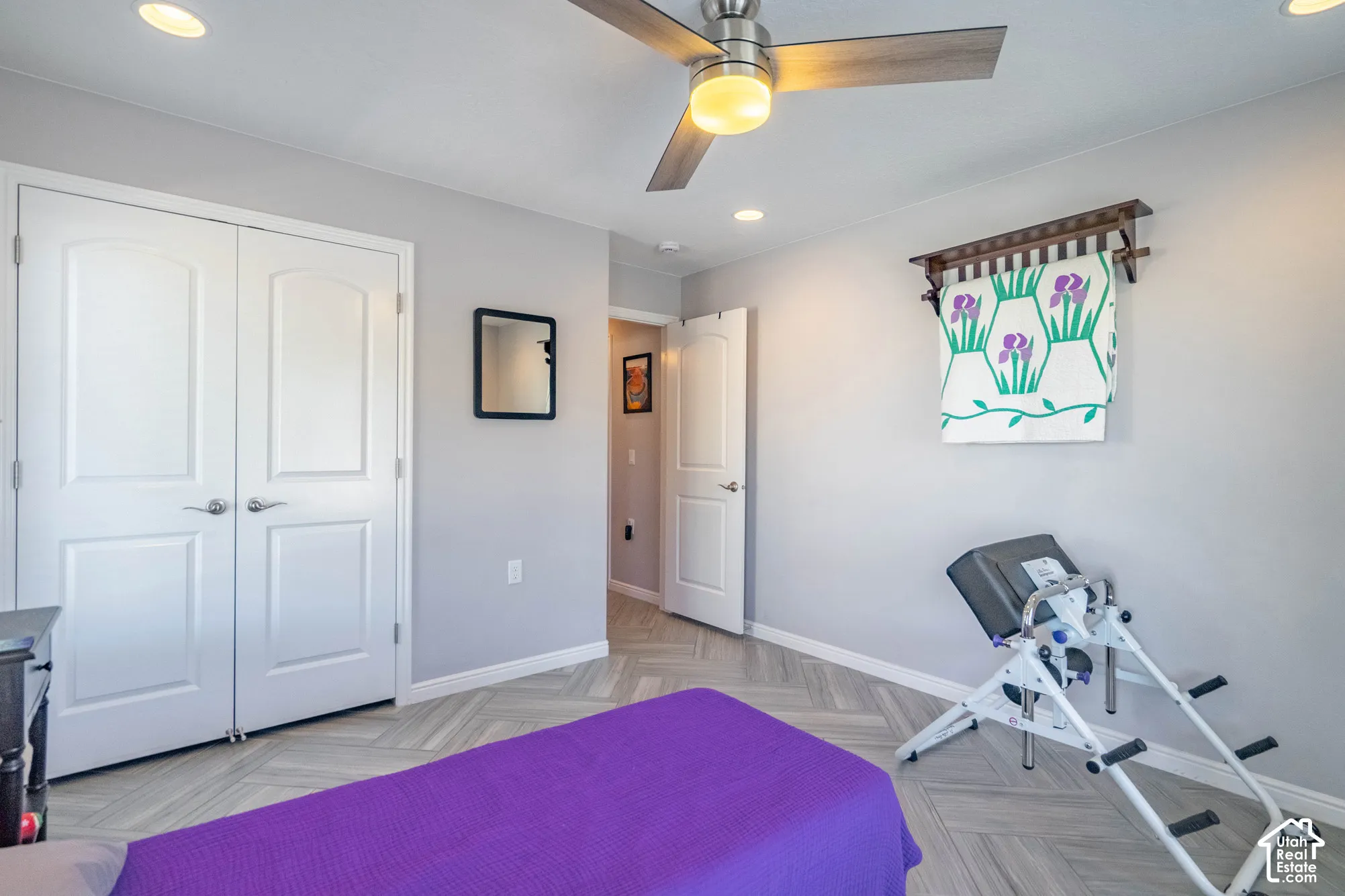 Herringbone-patterned flooring, recessed lighting, brushed-nickel ceiling fan with integrated light, and double-panel doors