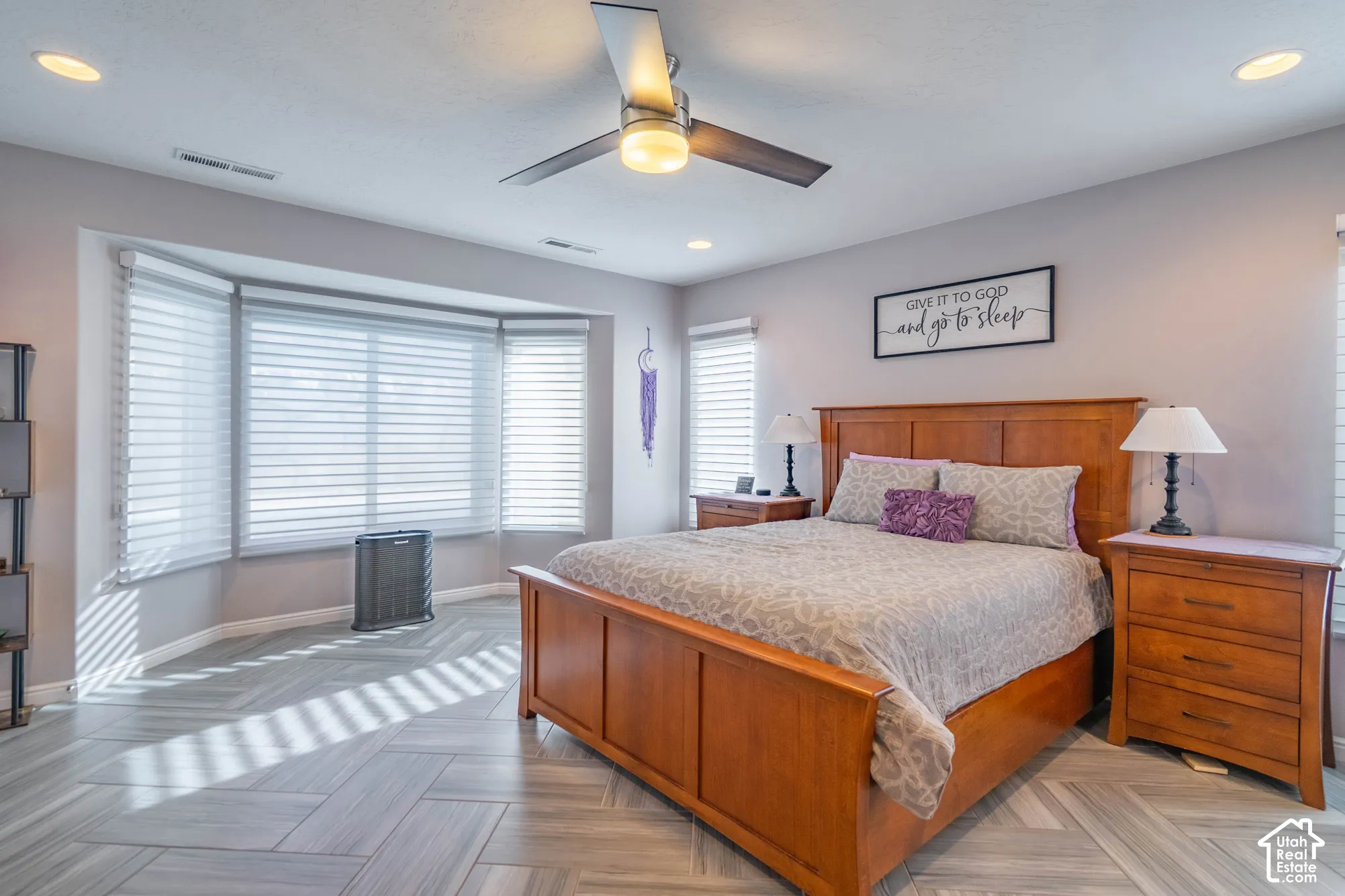 Room featuring large bay windows, herringbone-patterned tile flooring, recessed lighting, and a modern ceiling fan