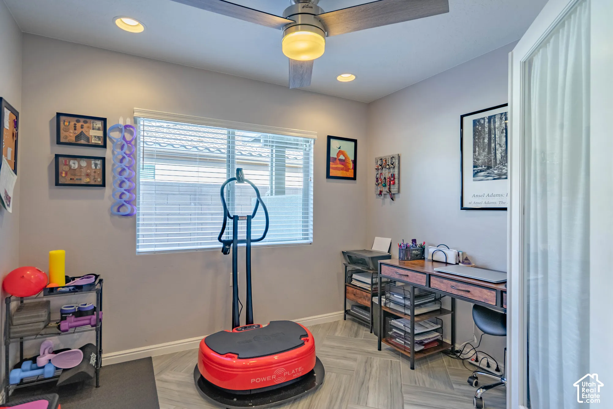 Room featuring herringbone-patterned tile flooring, recessed lighting, a ceiling fan with integrated light, a window with horizontal blinds, and a door with glass paneling
