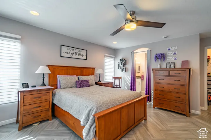 Herringbone-patterned tile flooring, recessed lighting, and a modern three-blade ceiling fan with integrated lighting