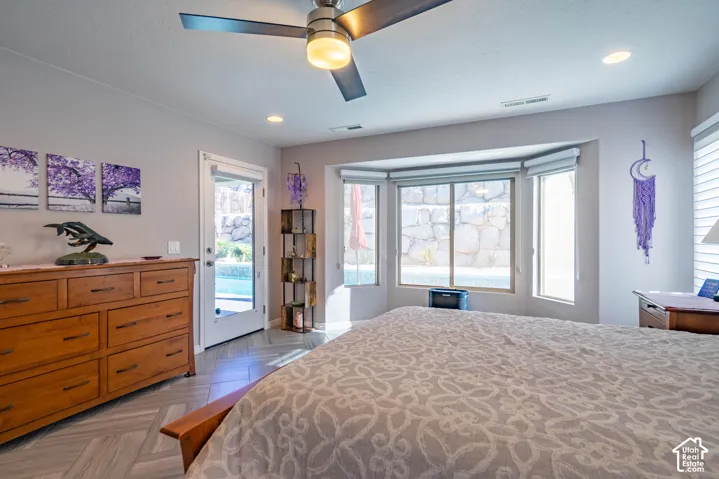 Herringbone-pattern tile flooring, ceiling fan with integrated lighting, recessed lighting, and a bay window configuration featuring a glass-panel exterior door