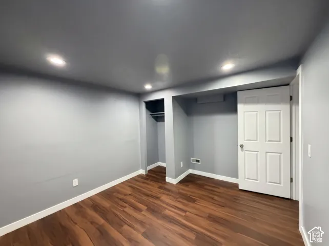 Interior room featuring wood-finish flooring, recessed lighting, and a built-in closet with integrated shelving