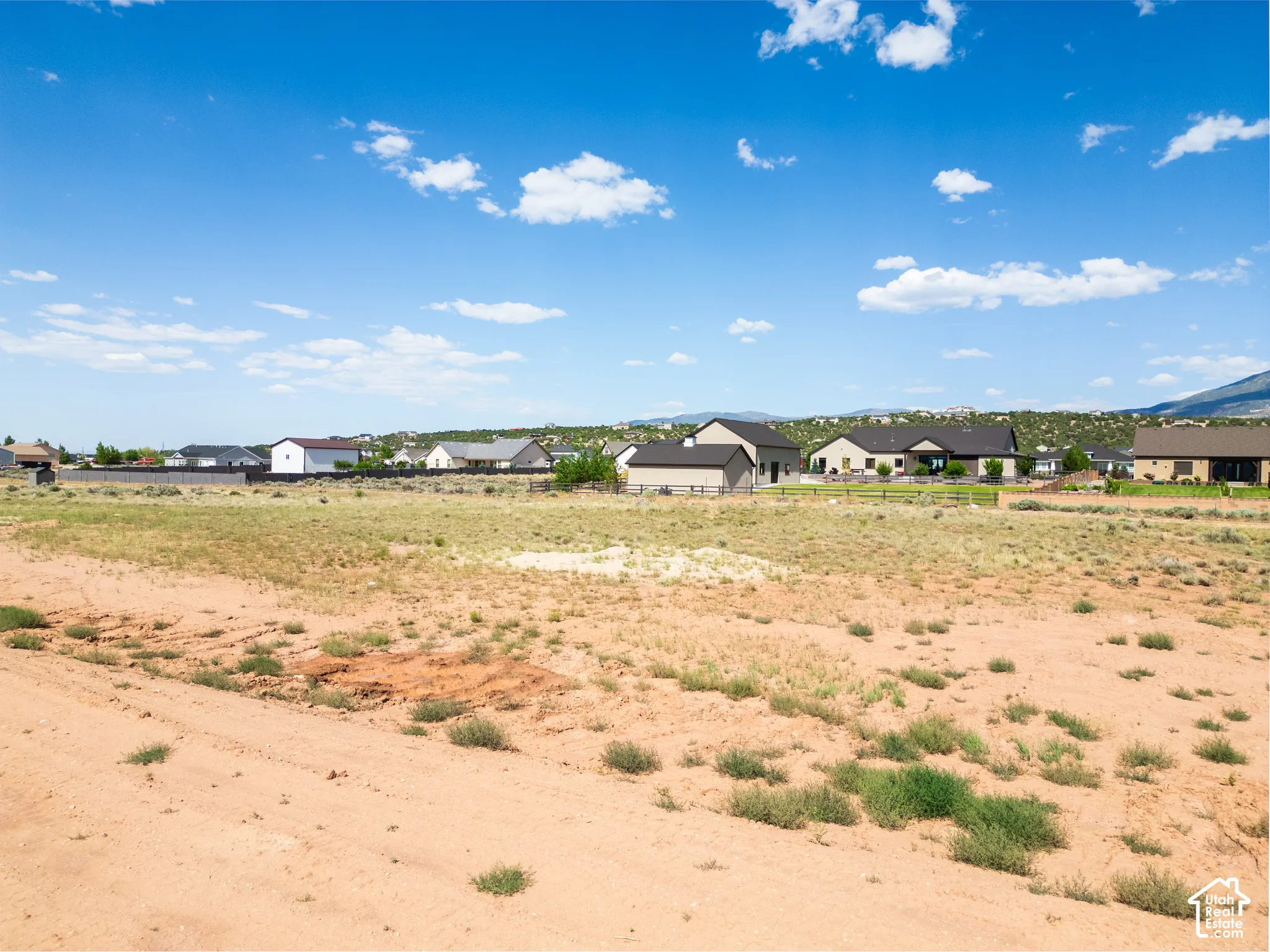 Expansive residential lot featuring native vegetation and a mountain backdrop