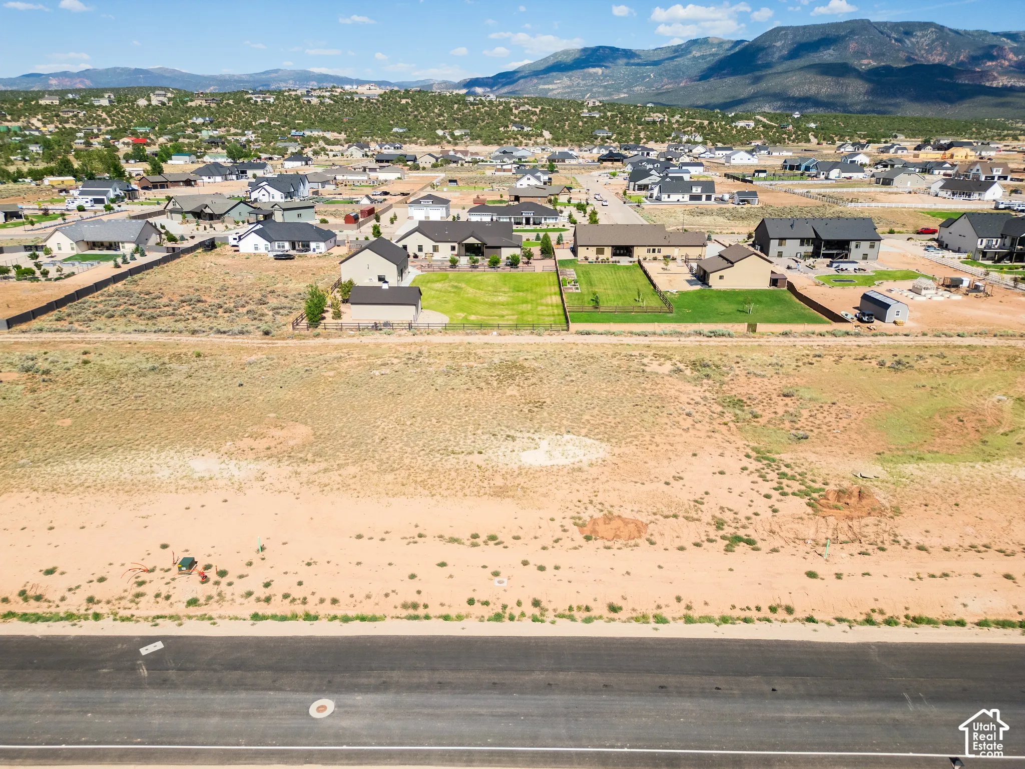 Expansive undeveloped residential lot featuring native desert landscaping and prominent mountain backdrops