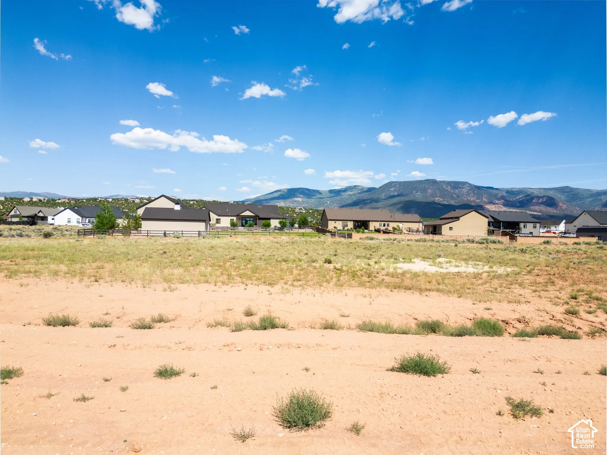 Expansive lot featuring native desert landscaping and prominent mountain scenery