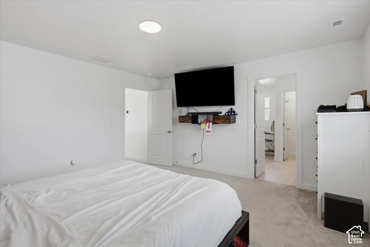 Interior space featuring neutral wall tones, wall-to-wall carpeting, and multiple interior paneled doors