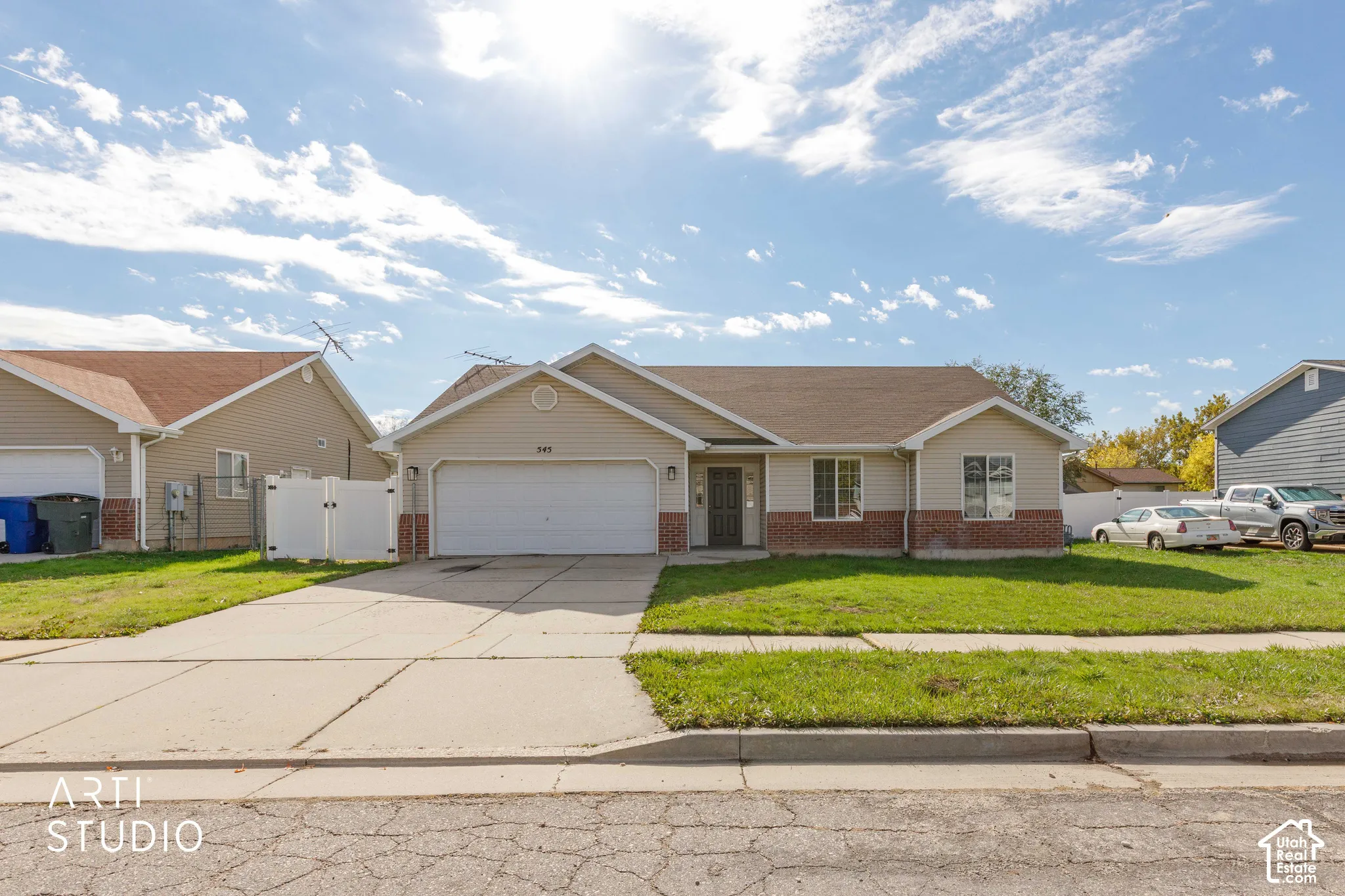 Single-story residence featuring a horizontal siding and brick veneer exterior, attached two-car garage, concrete driveway, and front lawn