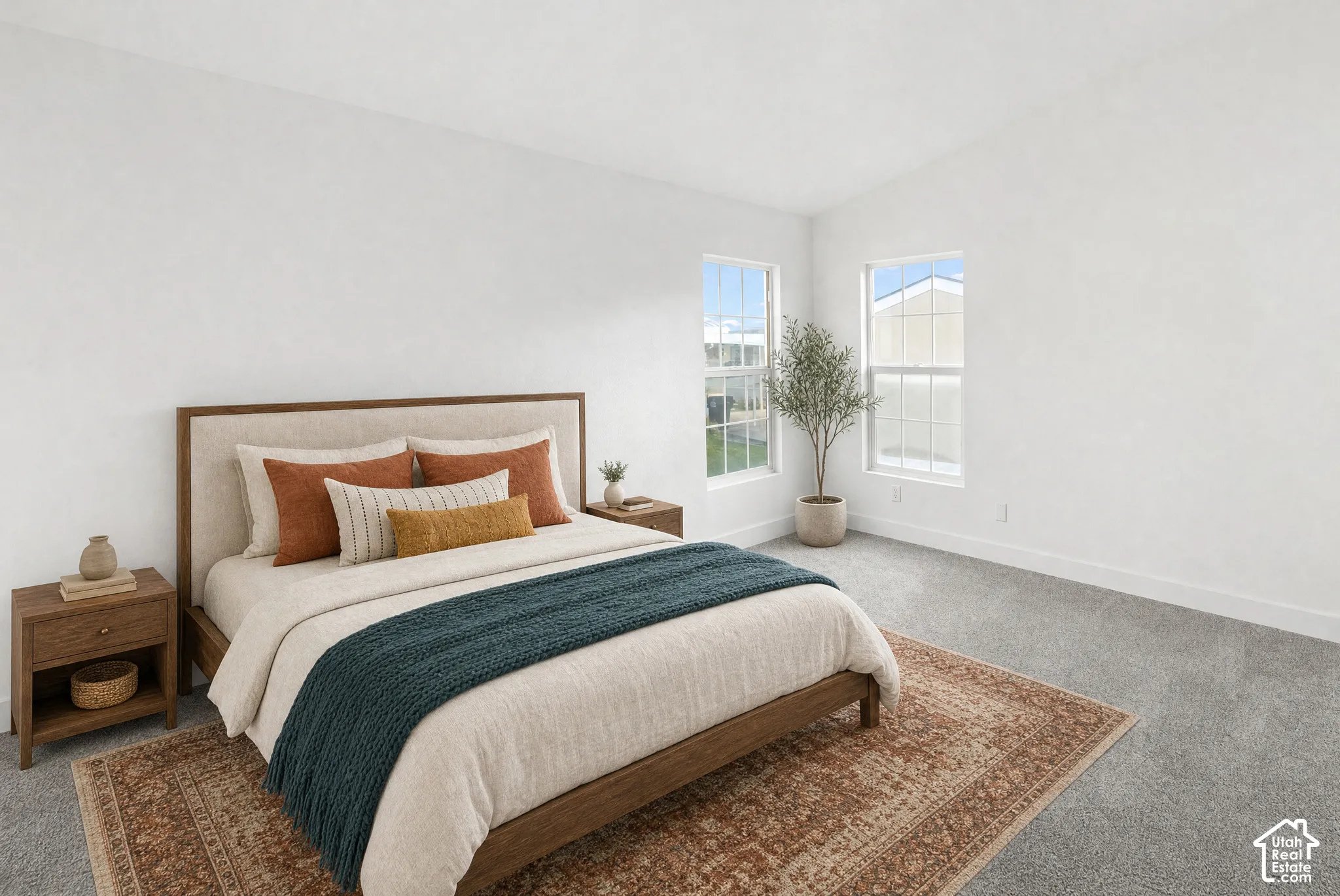 Neutral-toned interior space featuring vaulted ceilings, plush carpeting, and multi-pane windows