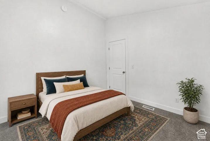 Neutral-toned interior room featuring high ceilings, textured walls, wall-to-wall carpeting, and a two-panel interior door