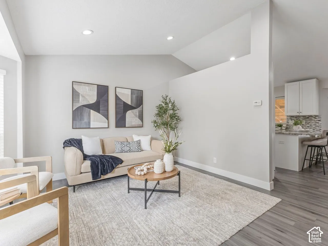 Vaulted ceilings, recessed lighting, and wood-finish flooring