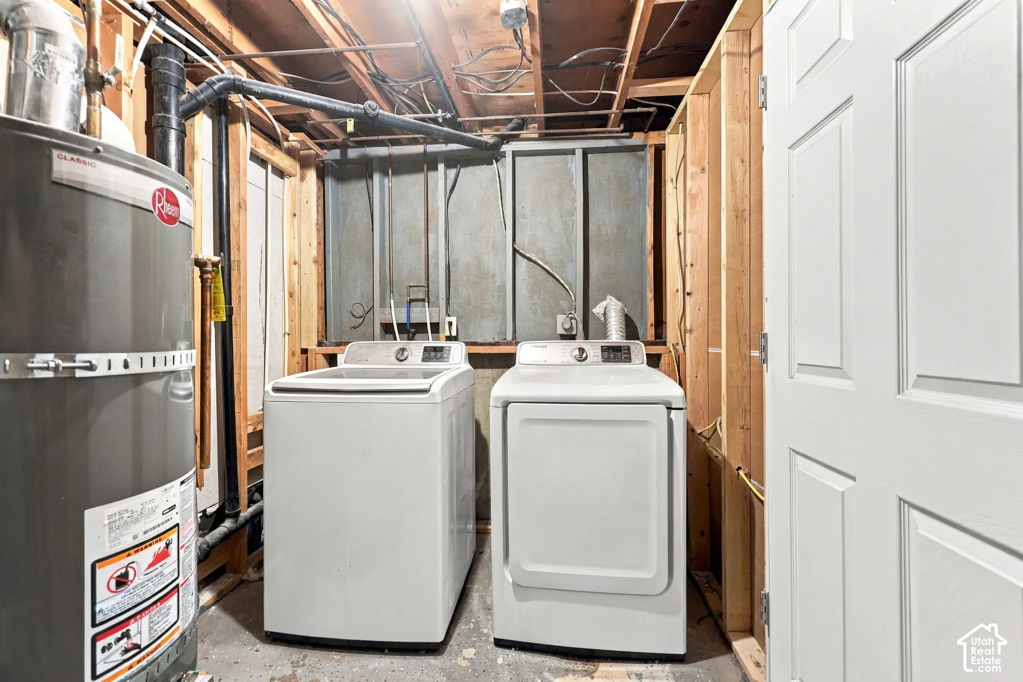 Laundry area with washer, dryer, water heater, and unfinished walls