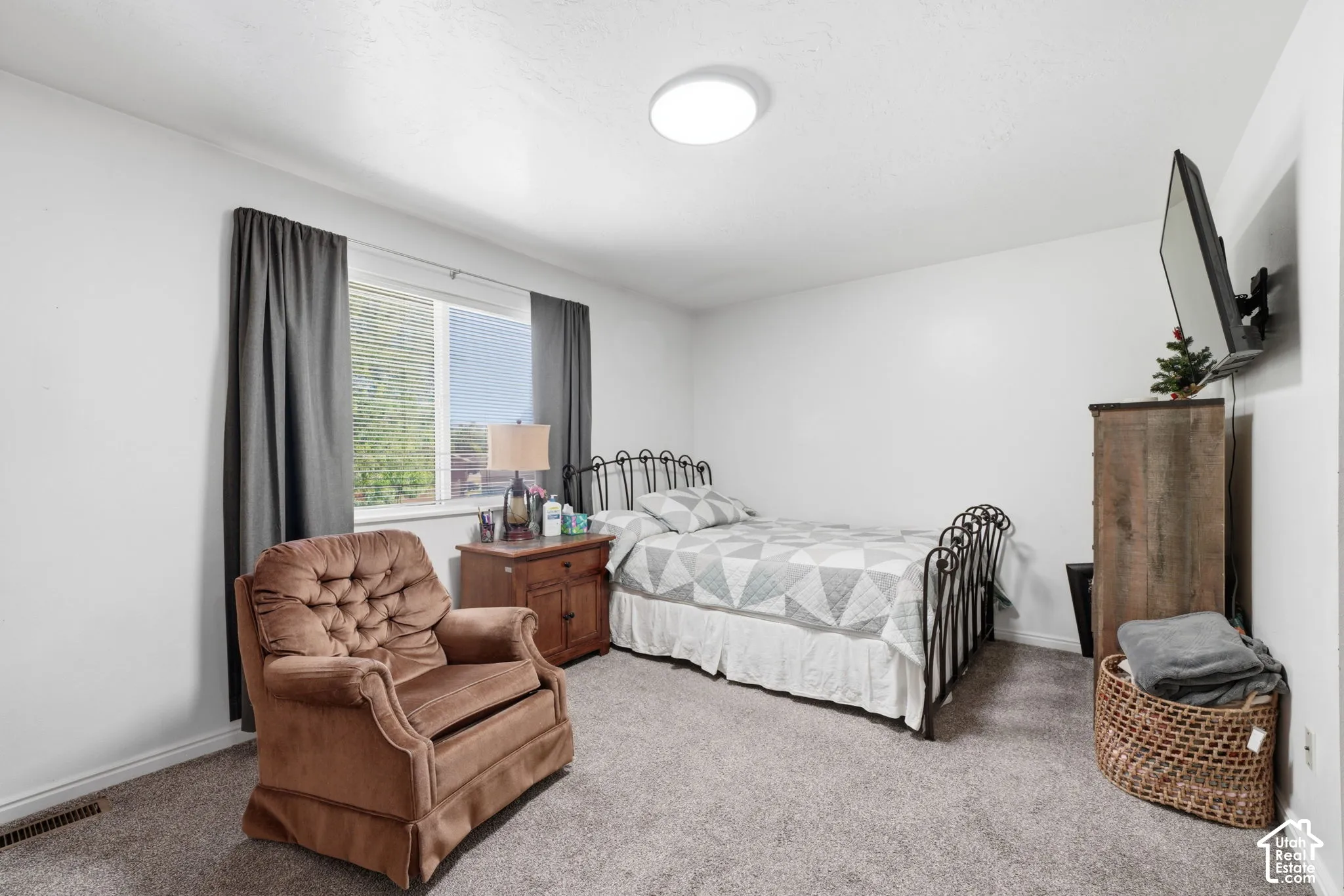 Neutral-toned wall-to-wall carpeting, window with natural light exposure, and flush-mount ceiling lighting