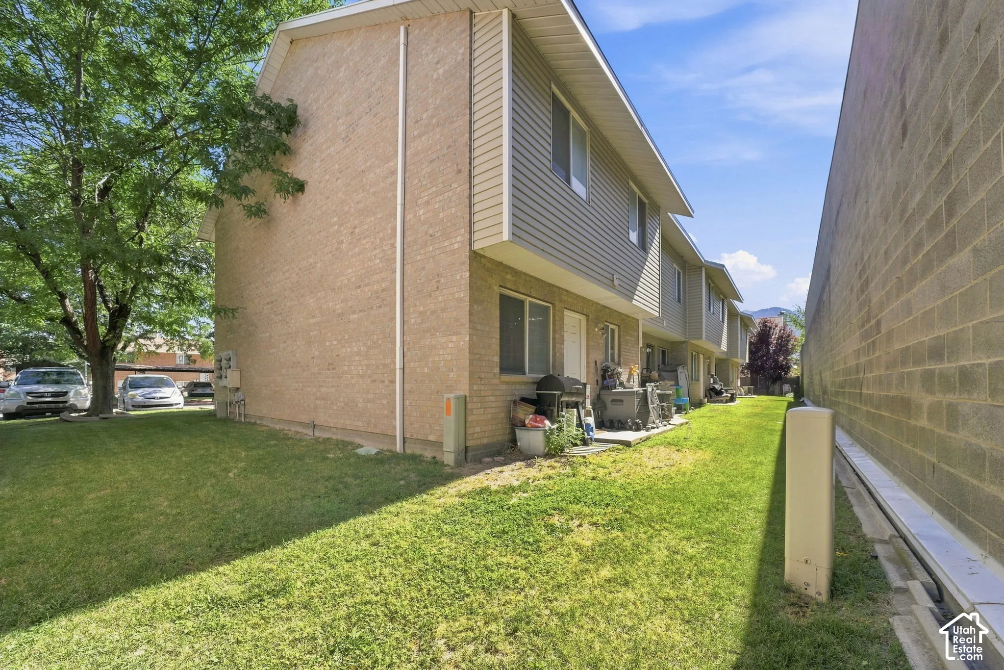 Exterior features a brick and horizontal siding facade with a dedicated lawn area and concrete exterior surfacing