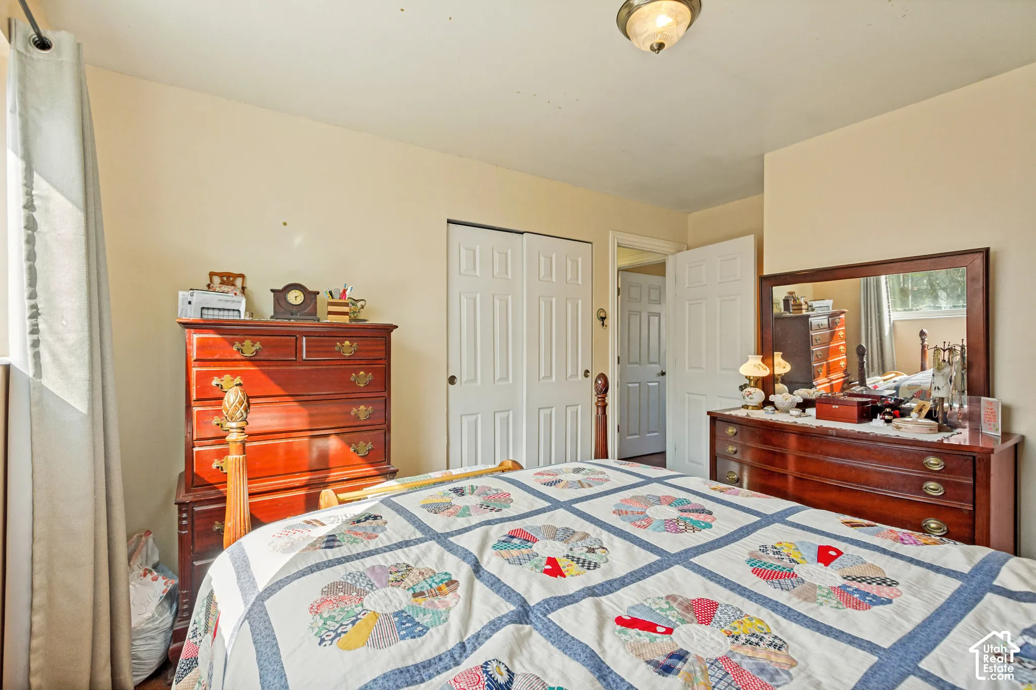 Bedroom featuring a double-door reach-in closet, neutral wall paint, and a flush-mount ceiling light fixture