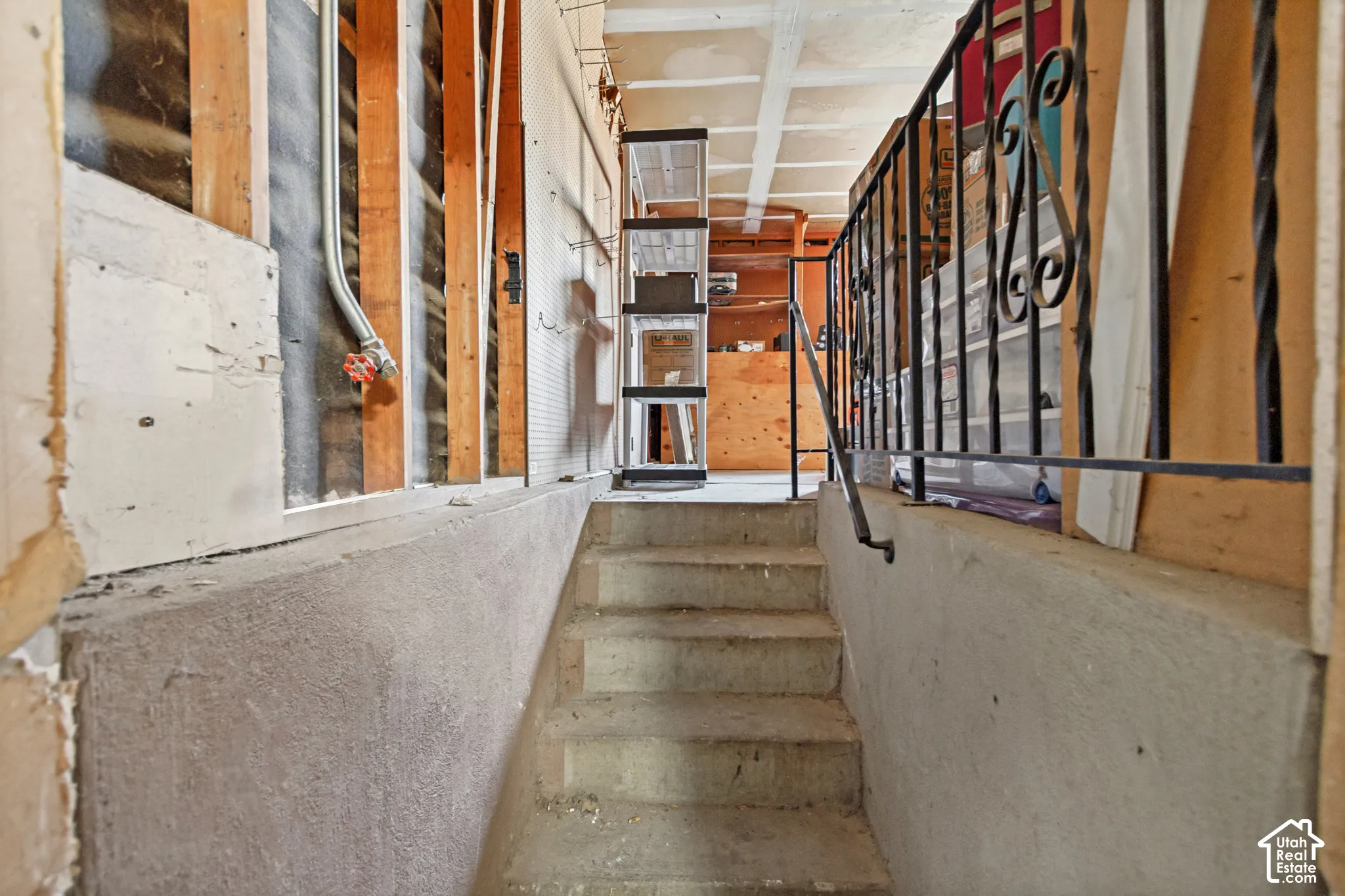 Concrete staircase with a metal decorative railing