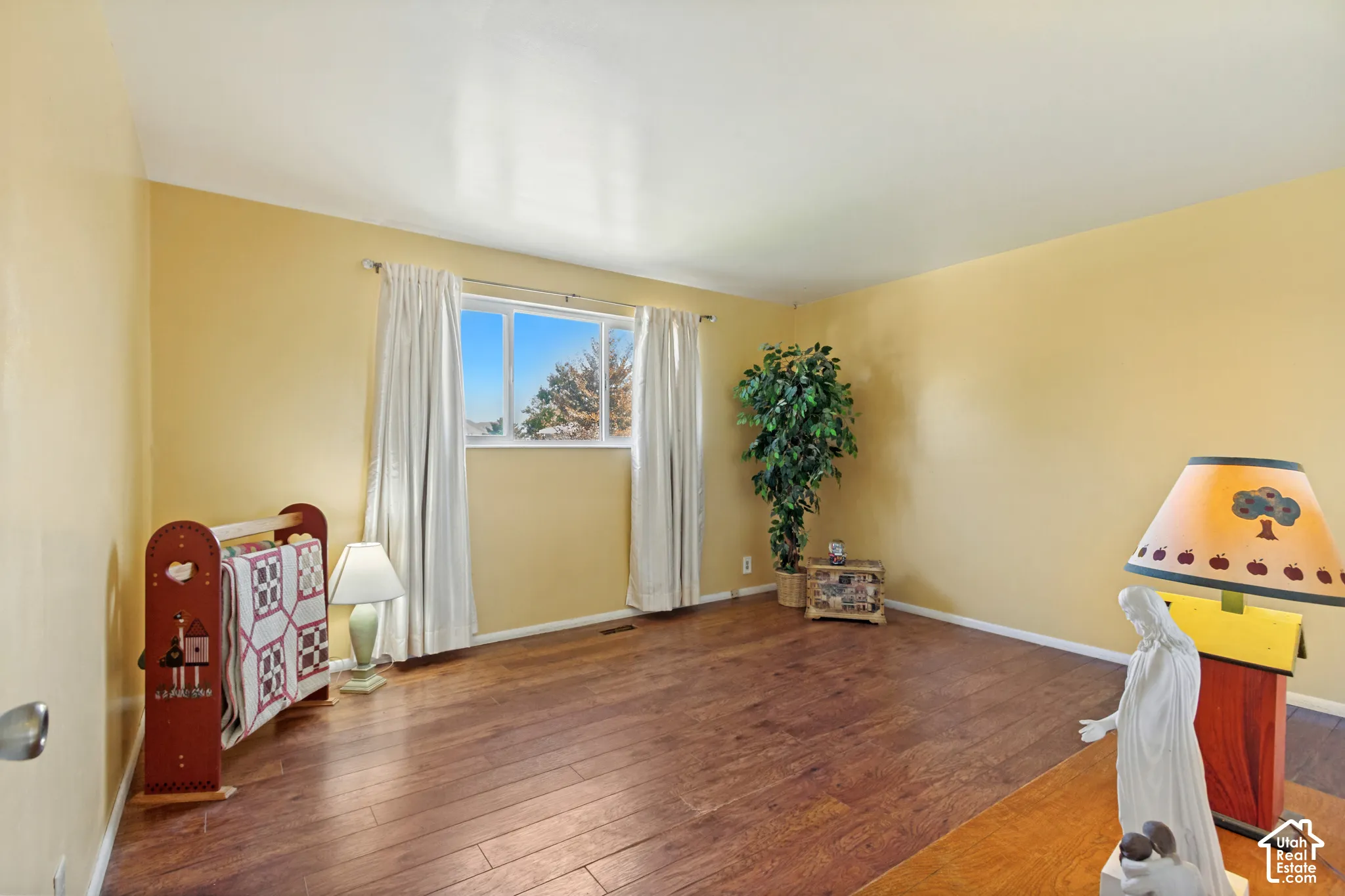Interior room featuring wood-finish flooring and a single-pane window
