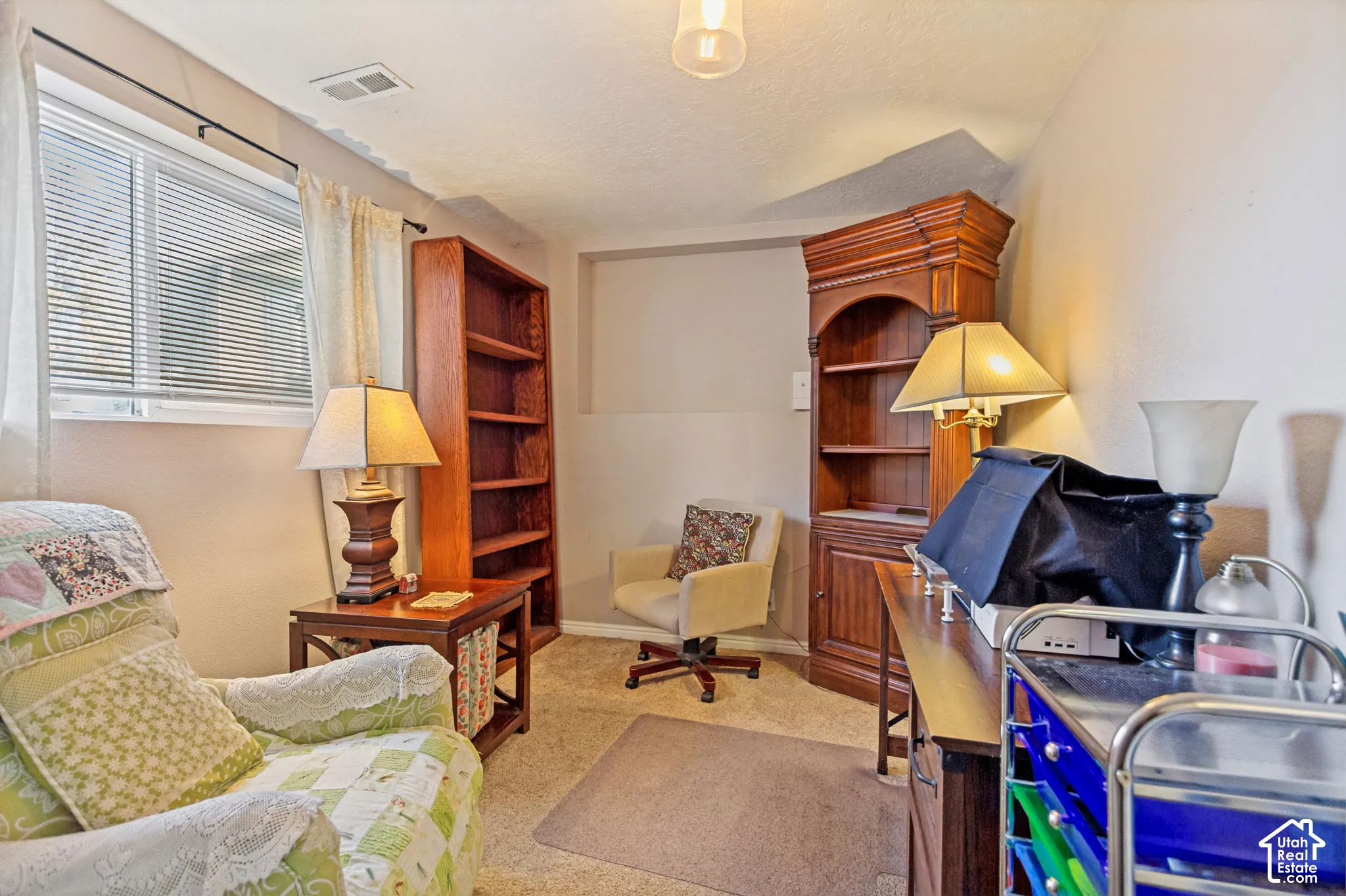 Built-in floor-to-ceiling wood shelving and recessed wall niche