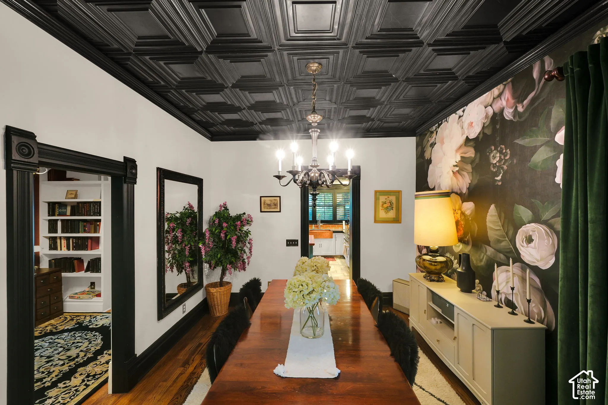 Black coffered ceiling, custom floral wall covering, original wood-finish flooring, and black-painted millwork featuring heavy door casings