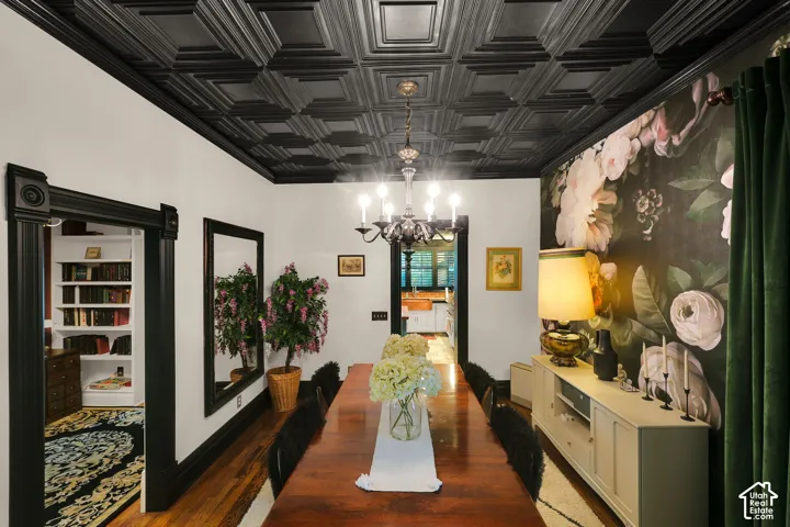Black coffered ceiling, custom floral wall covering, original wood-finish flooring, and black-painted millwork featuring heavy door casings