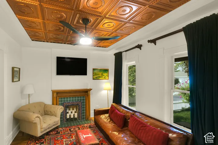 Copper-finished embossed coffered ceiling, wood-trimmed fireplace mantel, and decorative ceramic tile hearth