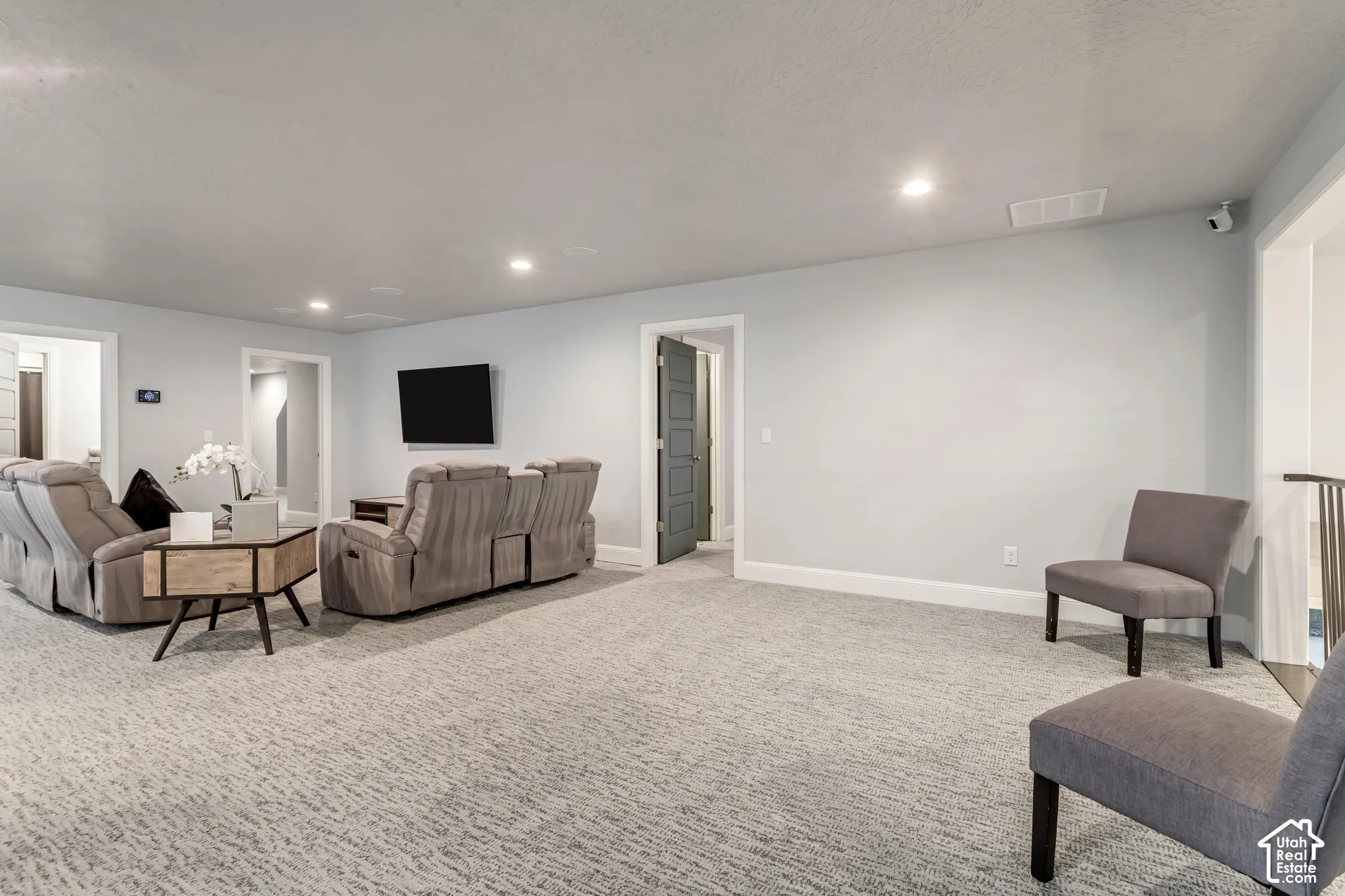 Neutral-toned interior space featuring recessed ceiling lighting, wall-to-wall carpeting, and solid-core interior doors