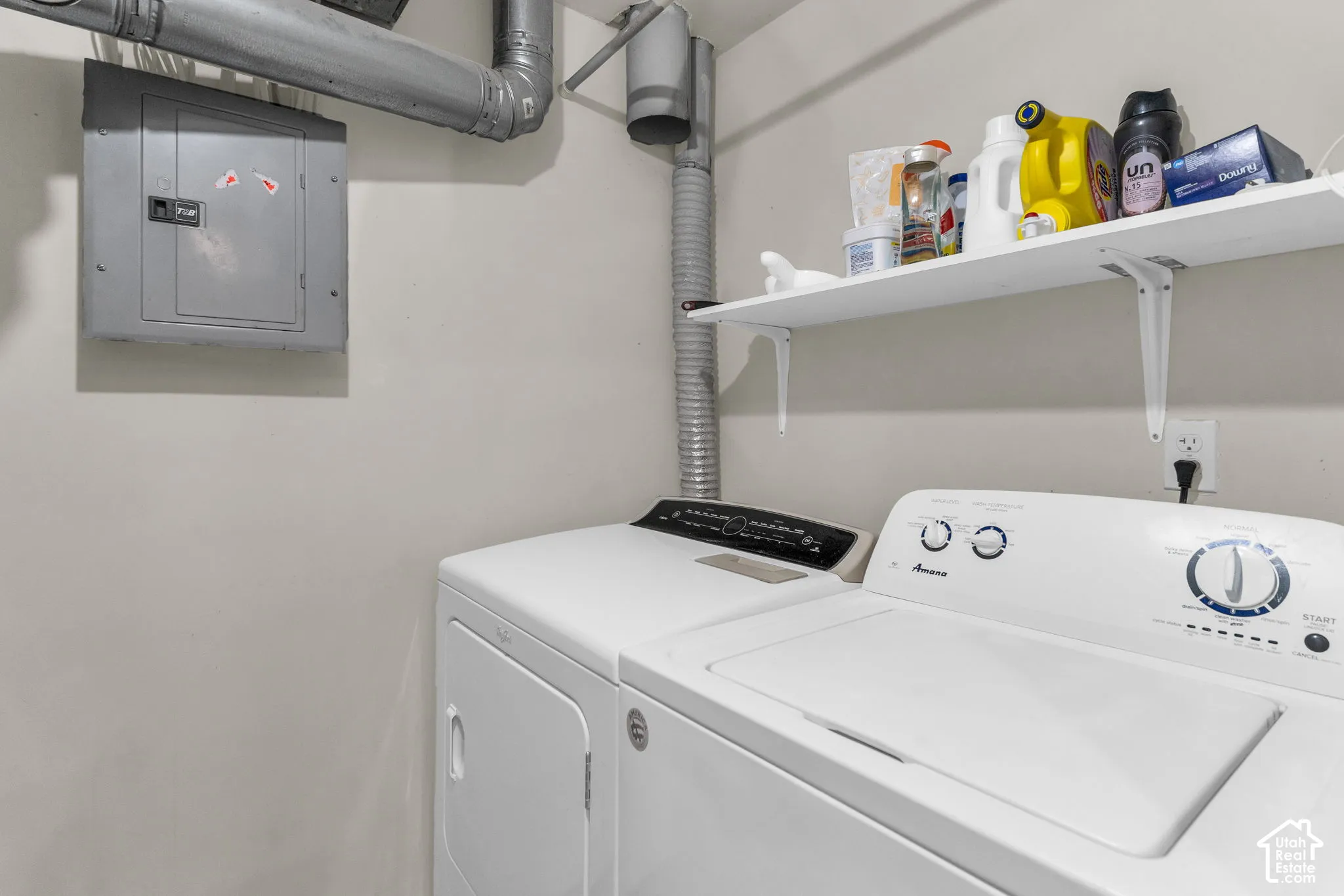 Wall-mounted shelving unit with painted brackets and dedicated electrical panel