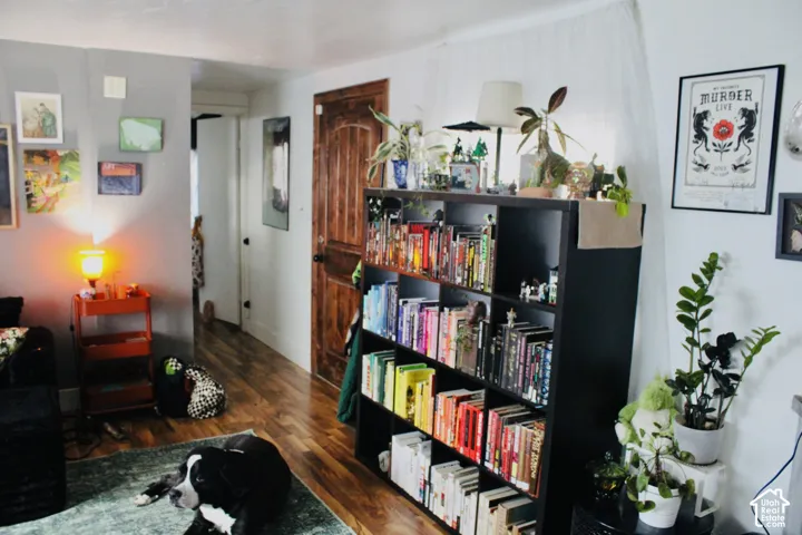 Interior space featuring wood-finish flooring and a solid wood arched-panel door