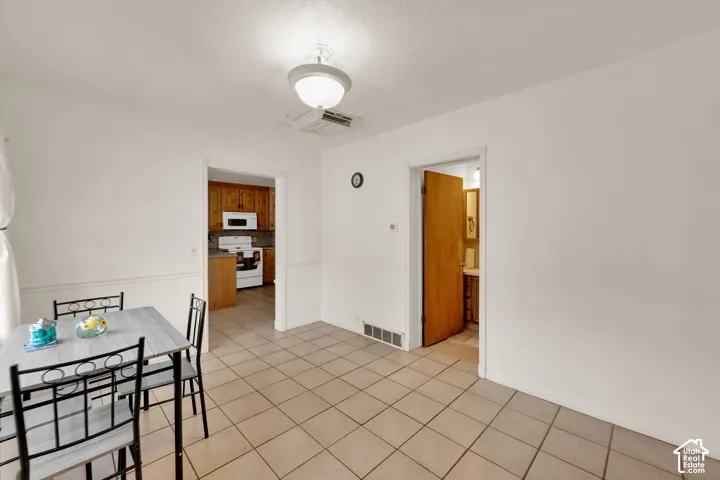 Ceramic tile flooring, semi-flush mount ceiling lighting, and wood-finish interior doors, used as dining area now.