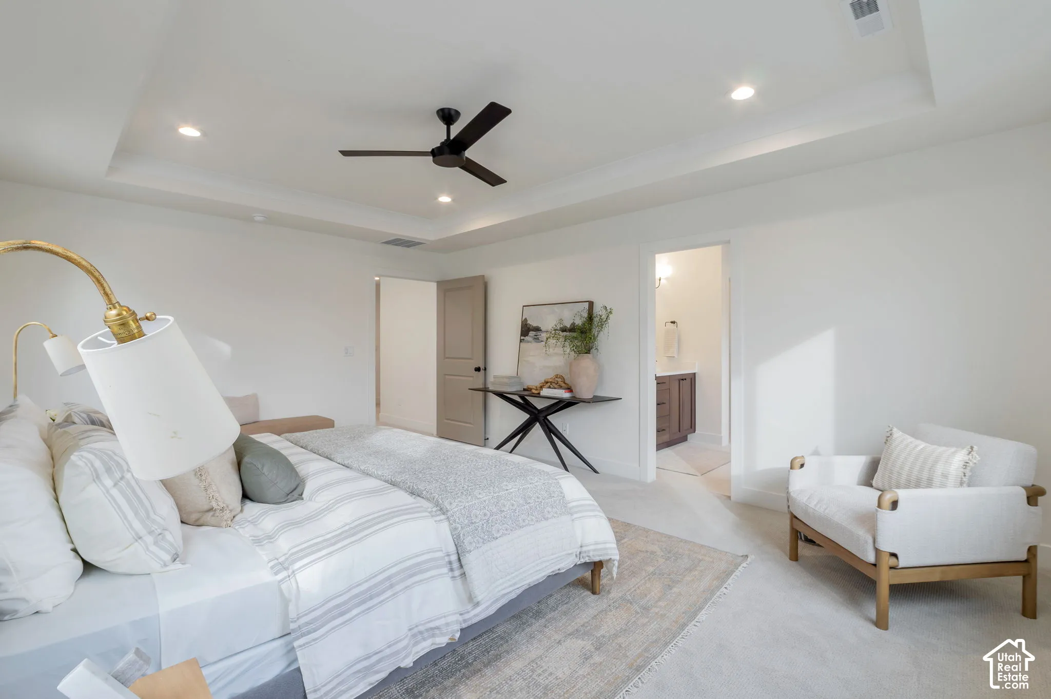 Tray ceiling featuring recessed lighting and a matte black ceiling fan