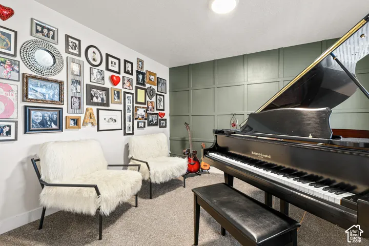 Interior room featuring a grid-patterned accent wall and neutral carpeting
