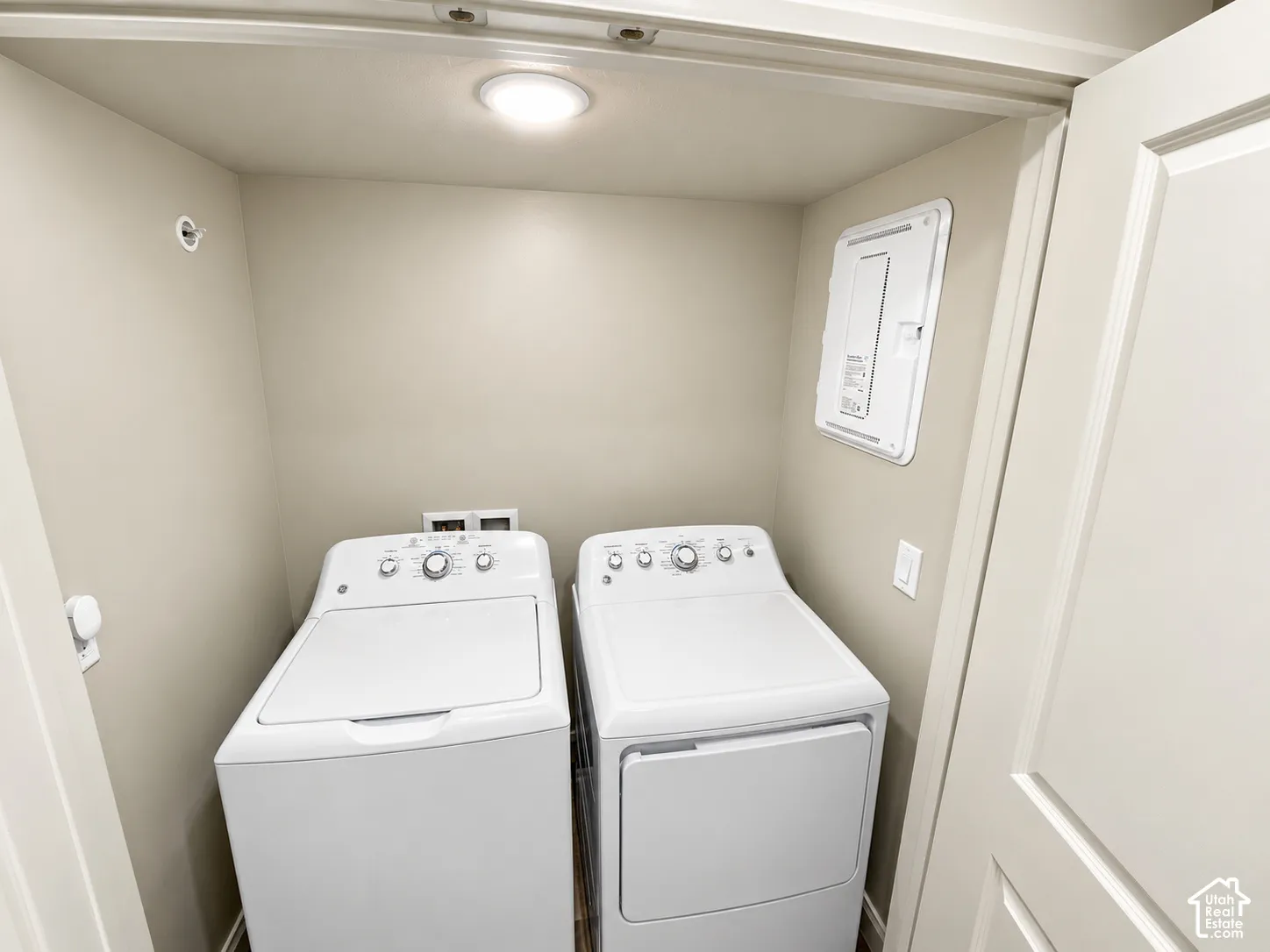 Laundry alcove featuring white top-load washing machine, white clothes dryer, recessed ceiling lighting, and panel door