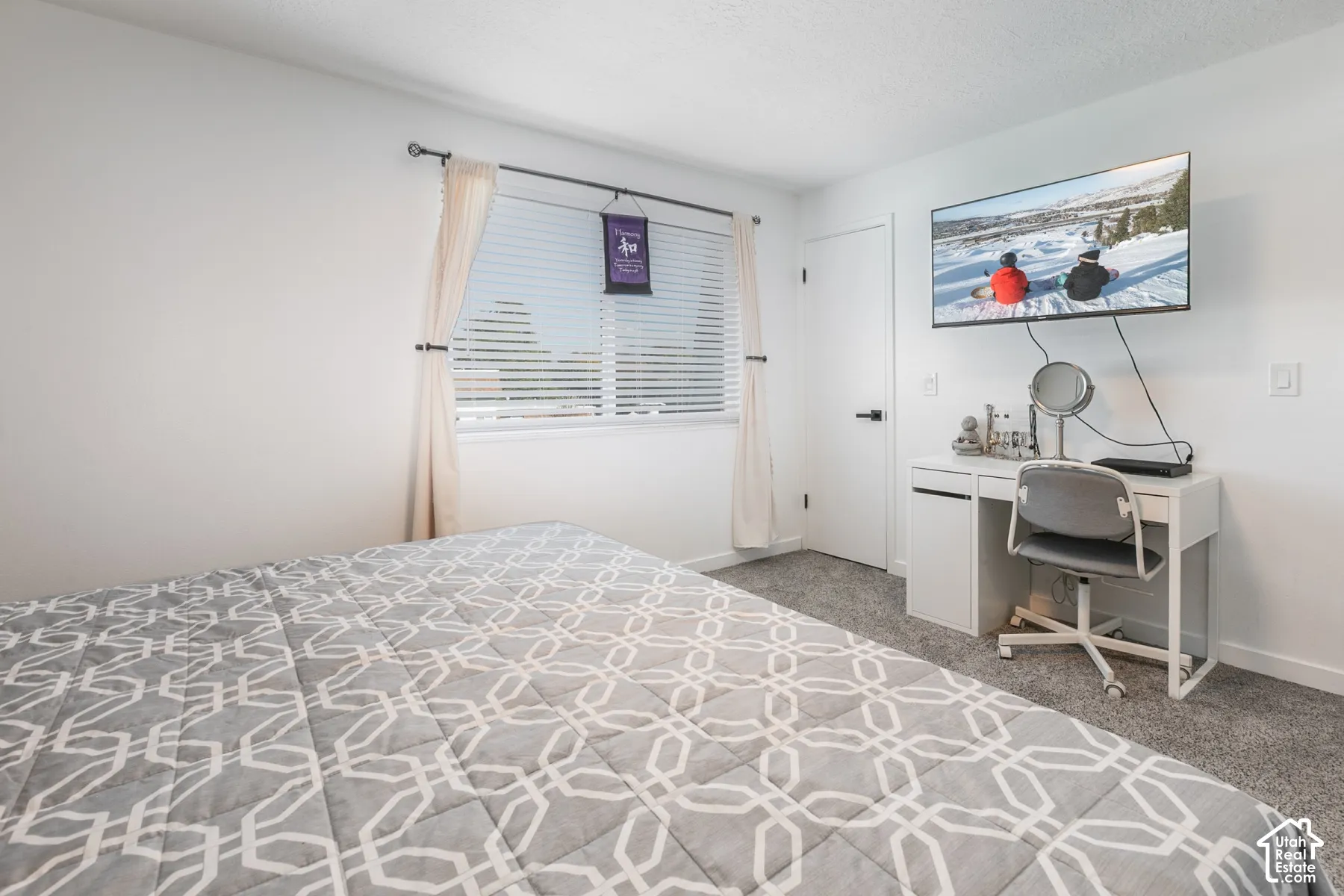 Bedroom featuring wall-to-wall carpeting and a window with horizontal blinds