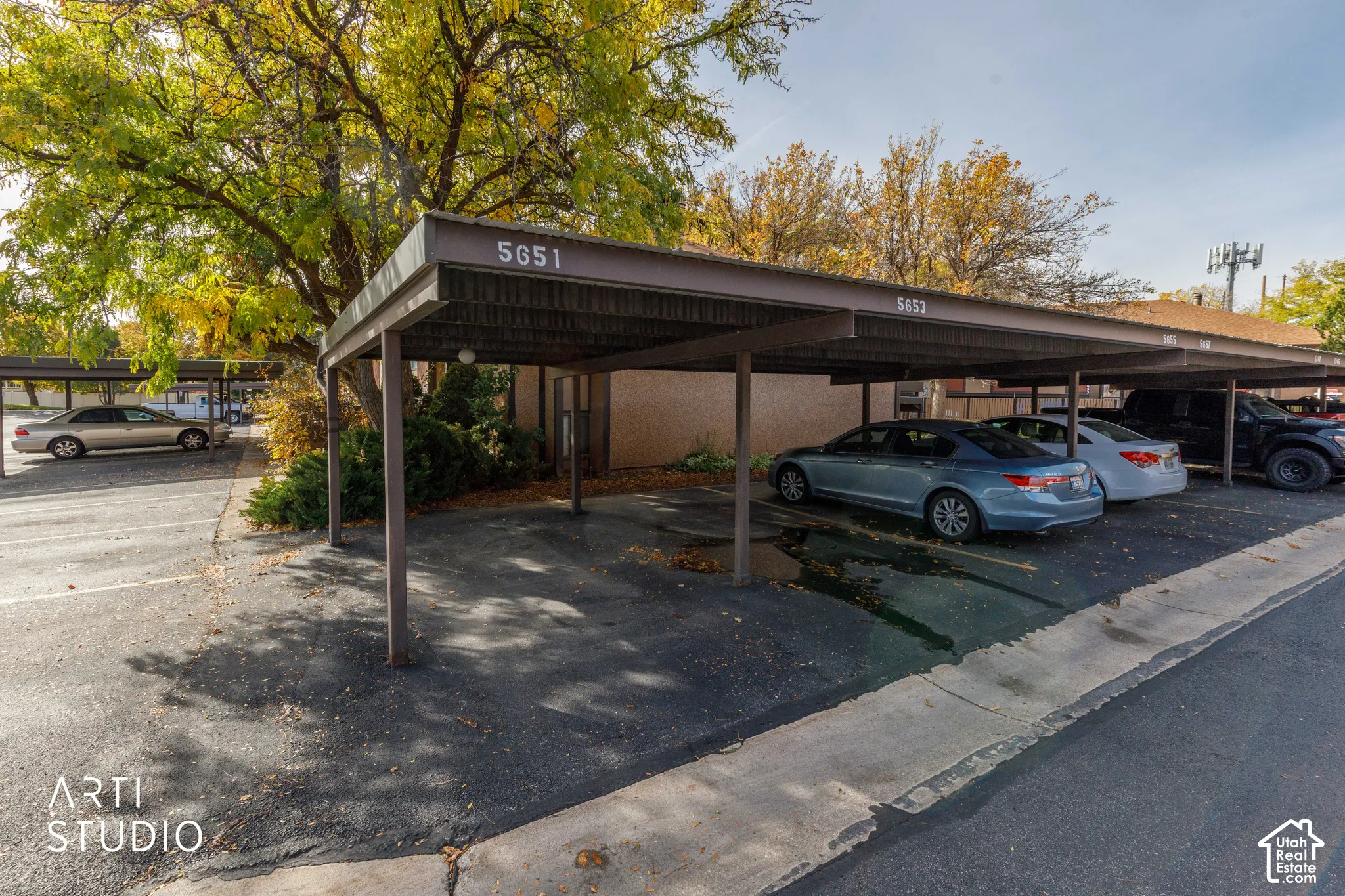 Covered parking structure with metal roofing and asphalt surfacing