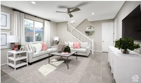 Living area featuring tile flooring, recessed lighting, a modern ceiling fan, and a staircase with white balusters