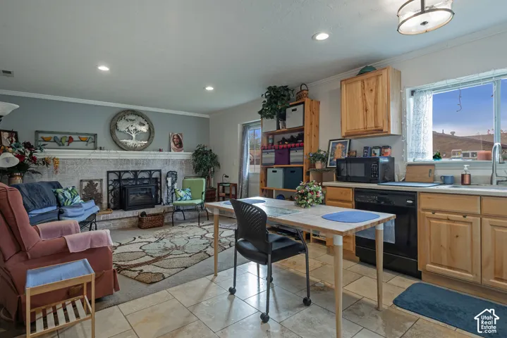 Kitchen and living area featuring tile flooring, masonry fireplace with a metal insert, natural wood cabinetry, and recessed lighting
