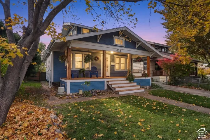 Craftsman-style exterior featuring horizontal siding, a covered front porch with exposed timber support beams, and an attic dormer window
