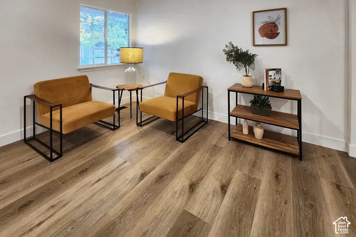 Neutral wall finish, wood-finish flooring, and single-pane sliding window