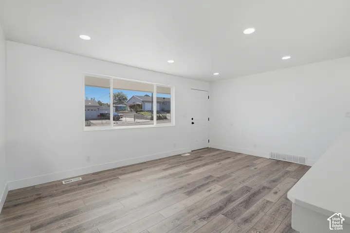 Interior space featuring wood-finish flooring, recessed lighting, and a large horizontal window