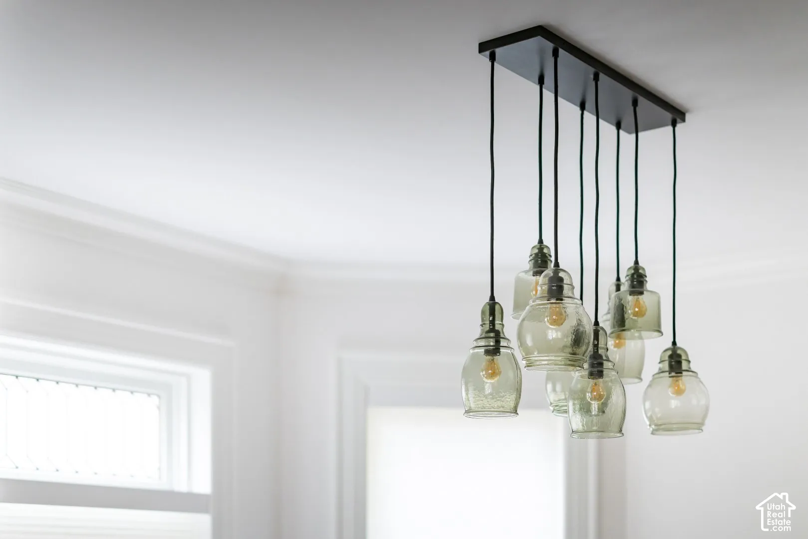 Multi-light pendant fixture featuring seeded glass globes suspended from a black rectangular canopy