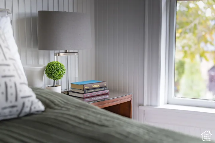 Vertical beadboard wall paneling and white-trimmed window casing