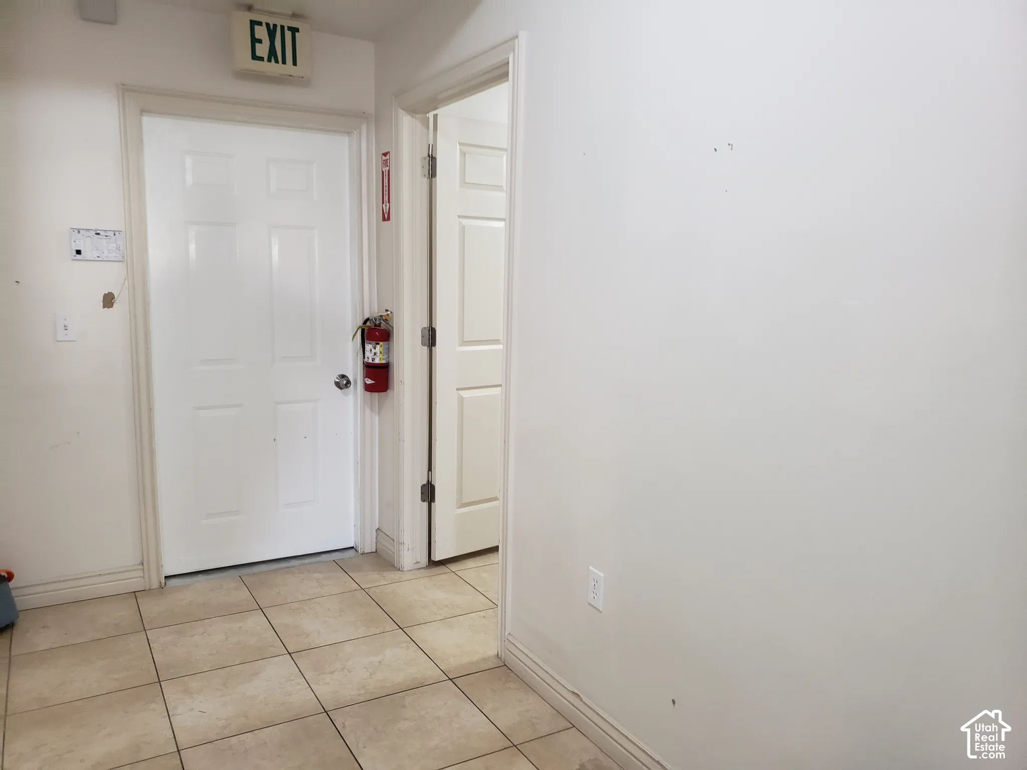 Interior space featuring tile flooring and two white six-panel doors