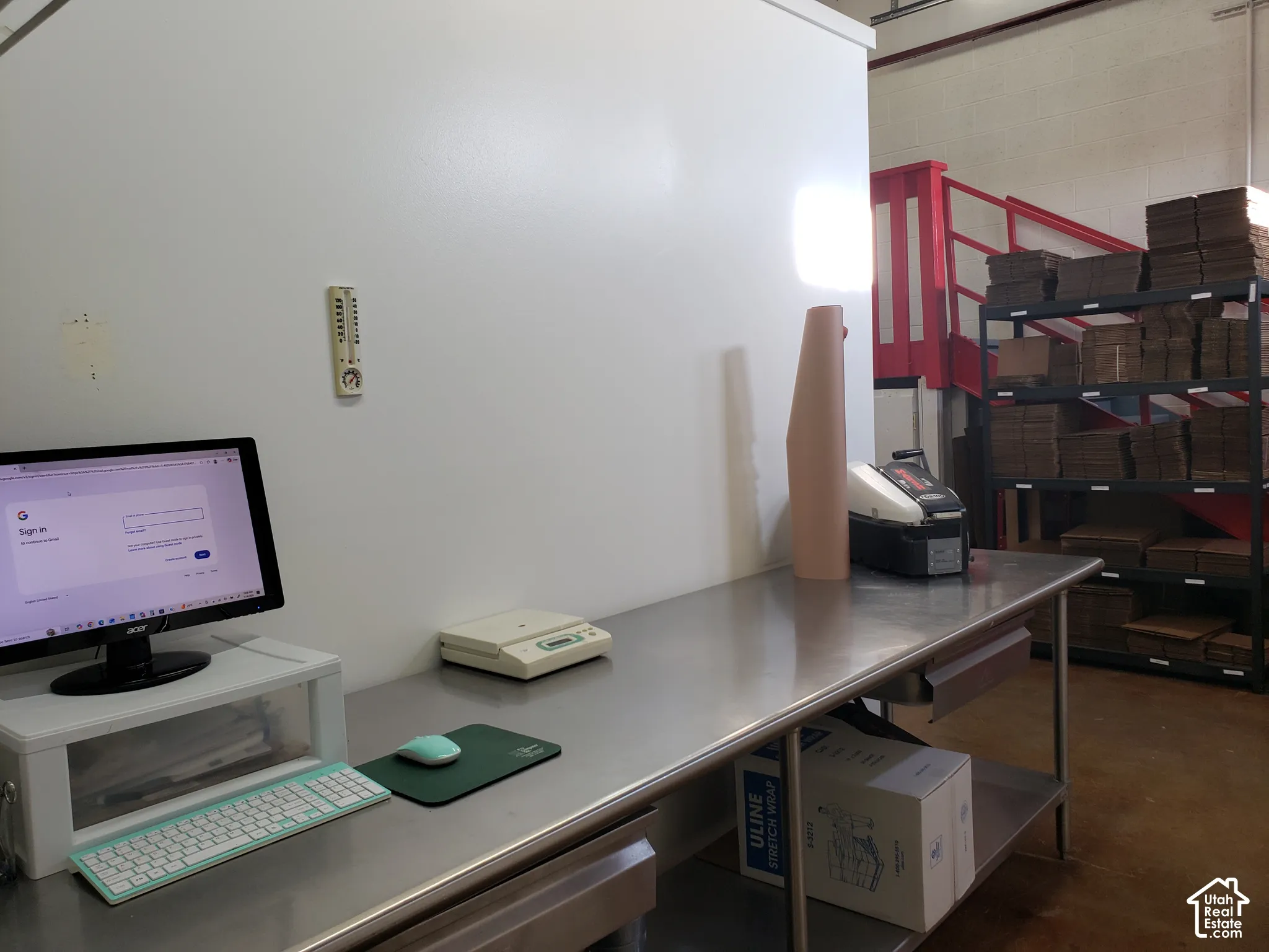 Stainless steel work table featuring a smooth metal surface, open shelving, and a clean, industrial workspace design
