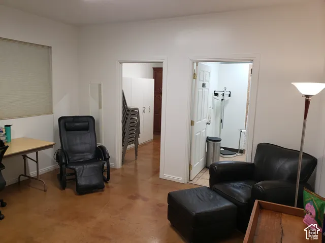 Polished concrete flooring throughout, white interior door frames, and custom built-in white storage cabinetry