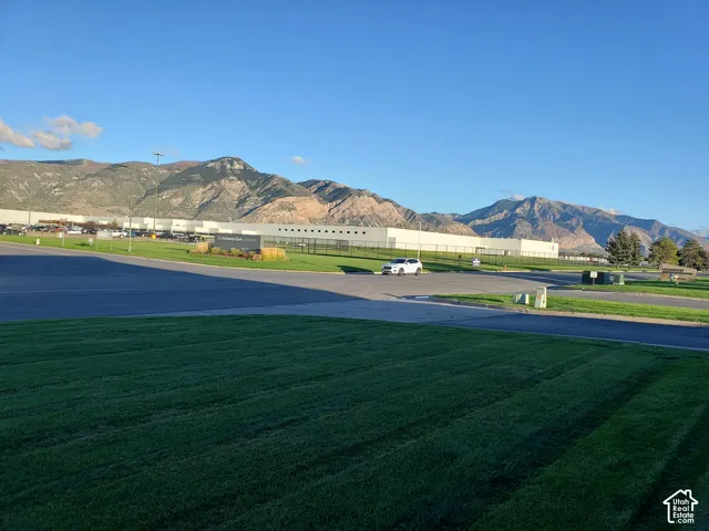 Expansive grounds featuring manicured turf and mountain backdrop