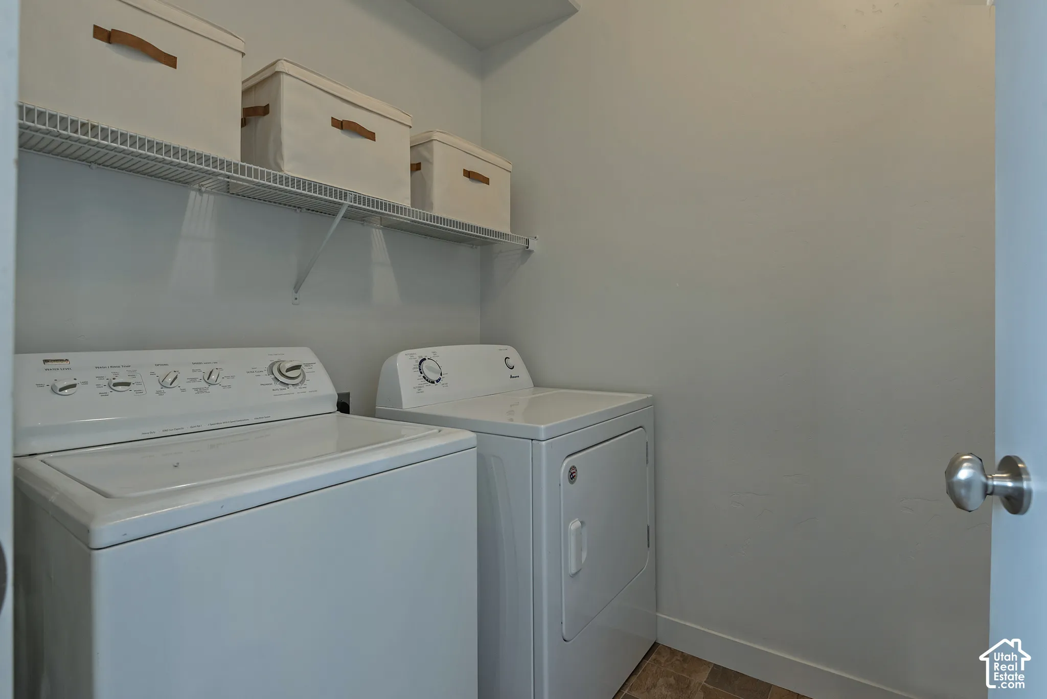 Dedicated laundry room featuring wire shelving and neutral-toned wall finishes